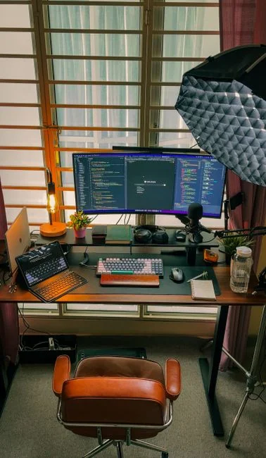 services-01 A tidy workspace with a sketchpad containing wireframes, a smartphone, and a keyboard on a wooden desk.